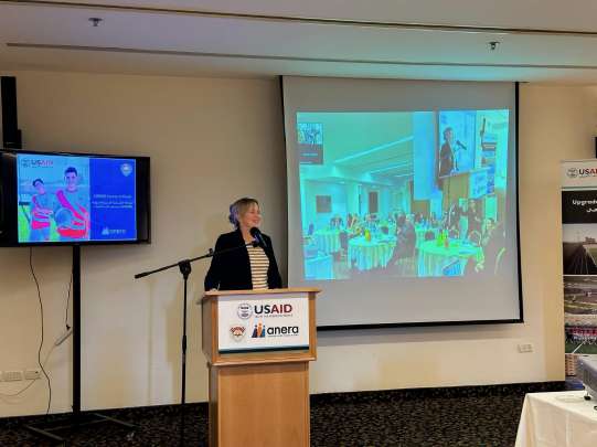 Speaker giving remarks at a podium during a USAID partner event
